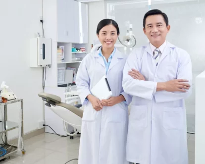 cheerful-asian-dentists-posing-treatment-room-clinic-front-equipment-1024x683.jpg.webp