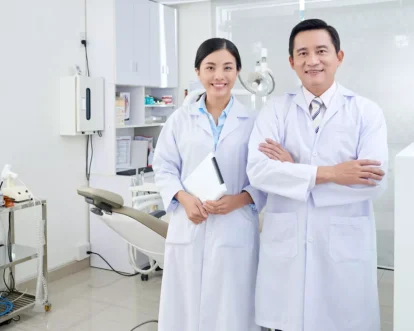cheerful-asian-dentists-posing-treatment-room-clinic-front-equipment-1024x683.jpg.webp